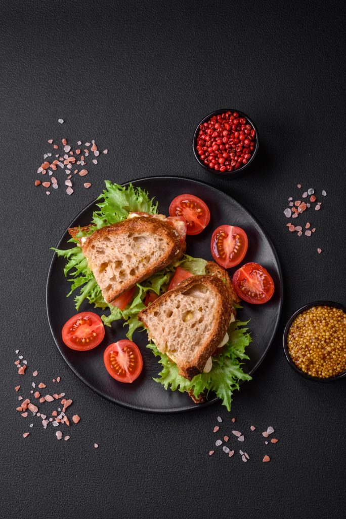 Delicious caprese sandwich with grilled toast, mozzarella, lettuce and tomatoes